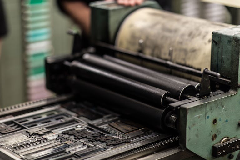 Detailed view of an industrial printing press with precise mechanics.